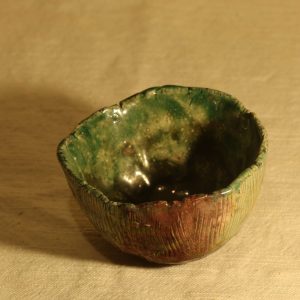 small raku bowl, green and copper, side vie
