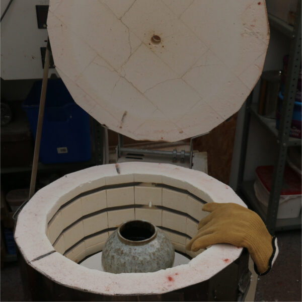 Electric kiln, opened showing a fired pot inside