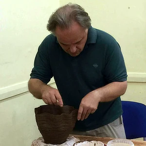 Tim Thornton hand building a pot